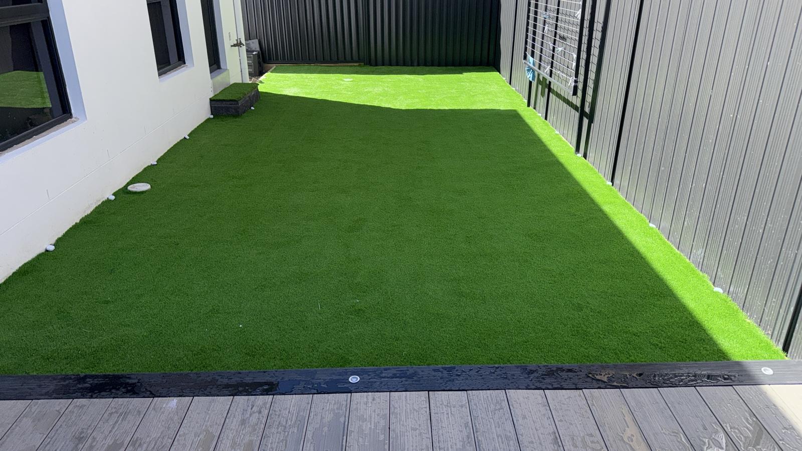 Completed synthetic turf backyard installation